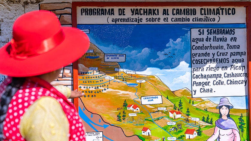 Carmen Shuan Vega, community leader in Ancash, shows a talking wall as a result of the learning process to strengthen local adaptation capacities