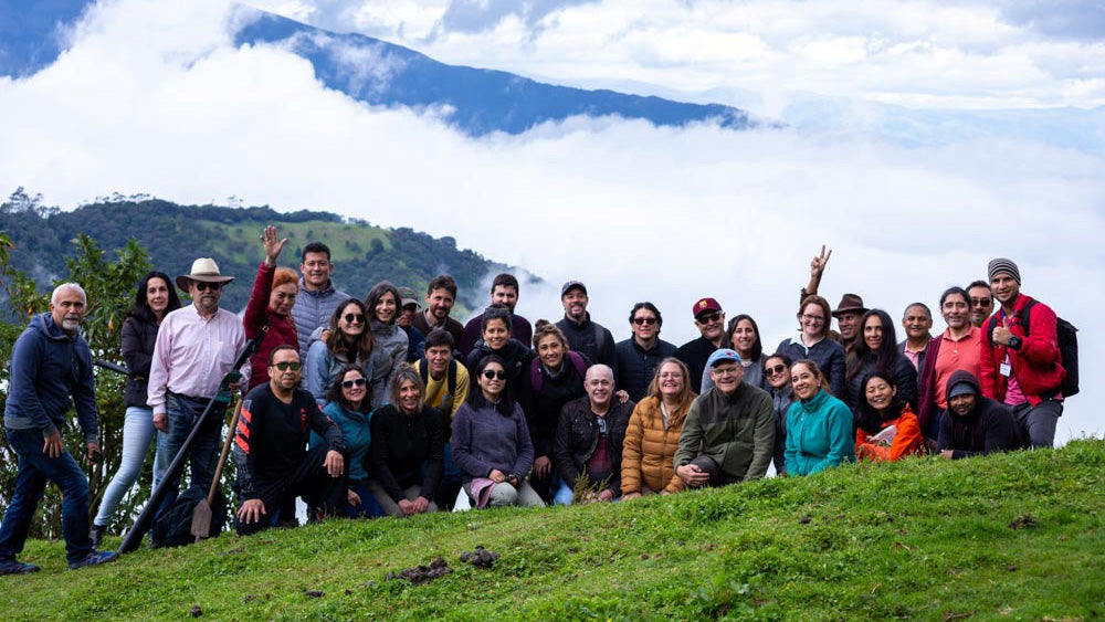 Group photo of workshop participants in front of a mountain landscape