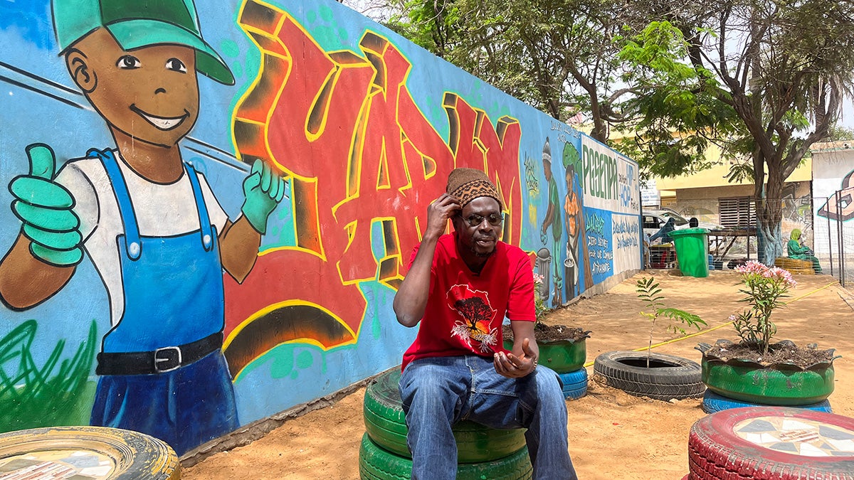 Man sitting in a cleaned up park area in Dakar, Senegal