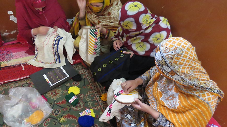 Women working in skill center doing the embroidery work