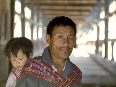 Portrait of man carrying child in Bhutan