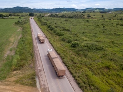 Trucks on a highway throught the Amazon forest in Brazil