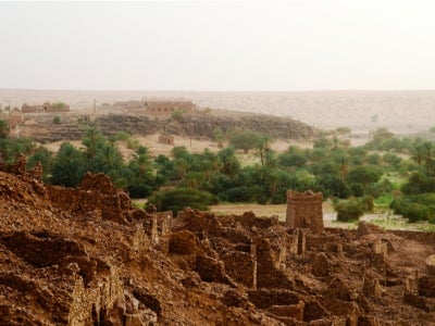 Ruins of the Ouadane fortress in Mauritania with trees