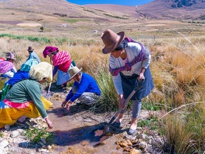 Communities in Huaraz work to maintain an irrigation canal