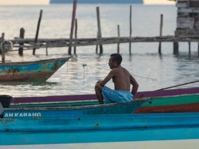 Man in fishing boat in Melanesia