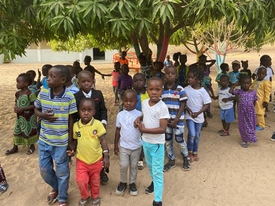 Senegalese children standing under mango tree