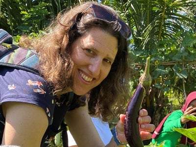 Woman holding eggplant on a farm