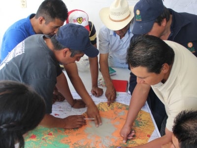 People looking at map on table