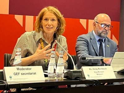 Woman gesturing and speaking at a panel event