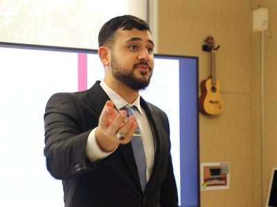Man gesturing while giving a presentation
