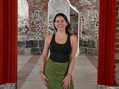 Woman standing within an empty red door frame