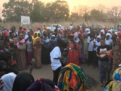 People gathered at sunset to participate in a community event