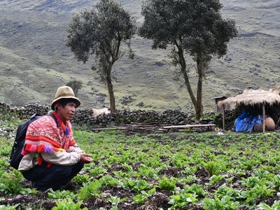 Peruvian man in foreground of mountain backdrop