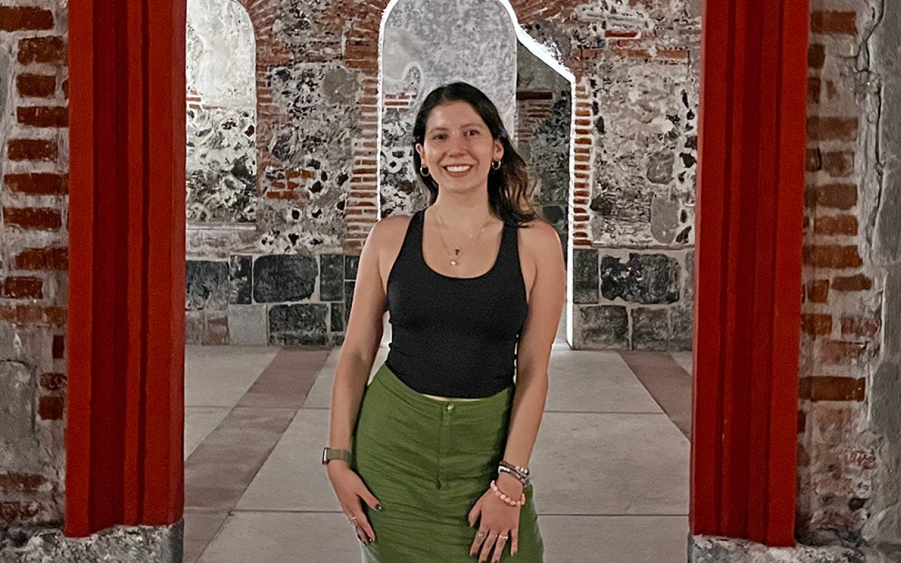 Woman standing within an empty red door frame