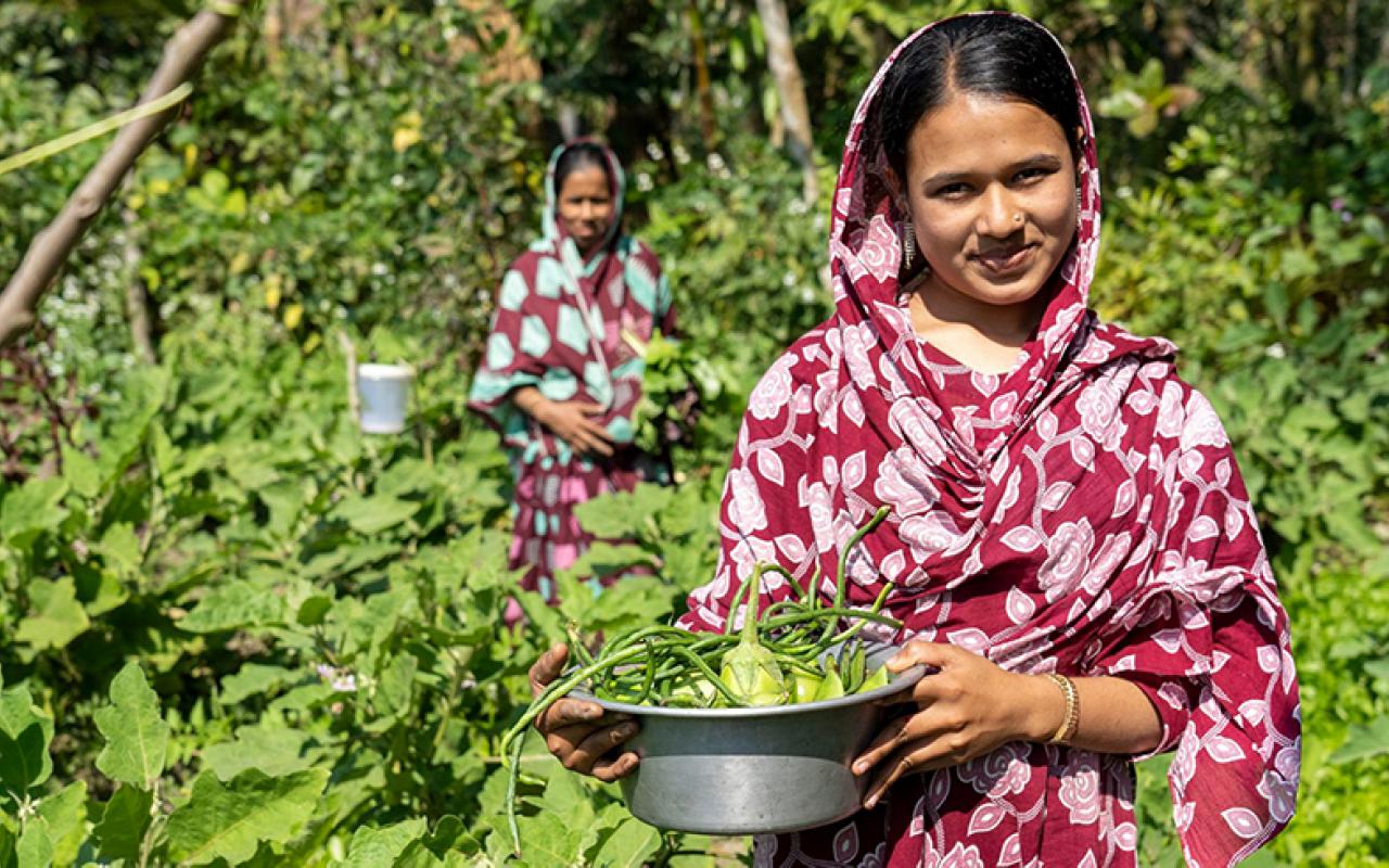 Bangladeshi woman holding crop haul