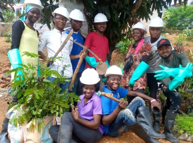 Group of students in hard hats posing for a photo