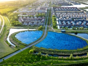 Modern sustainable neighborhood in Almere, The Netherlands. The city heating in the district is partially powered by a solar panel island. Aerial view.