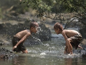 Children playing in river water