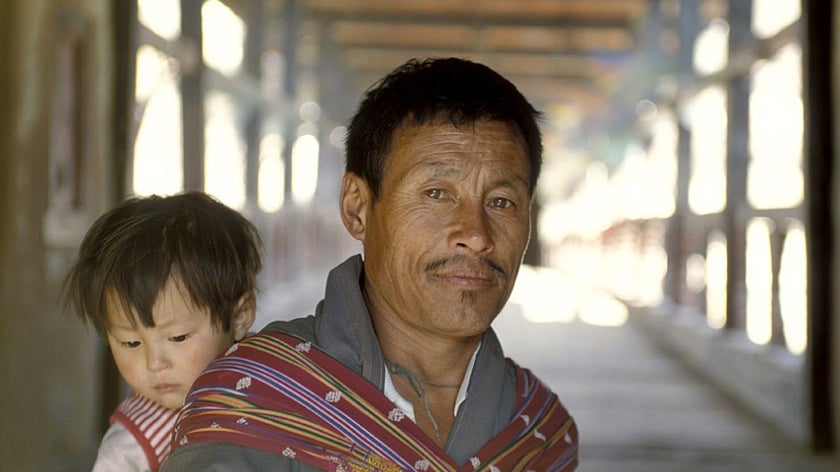 Portrait of man carrying child in Bhutan