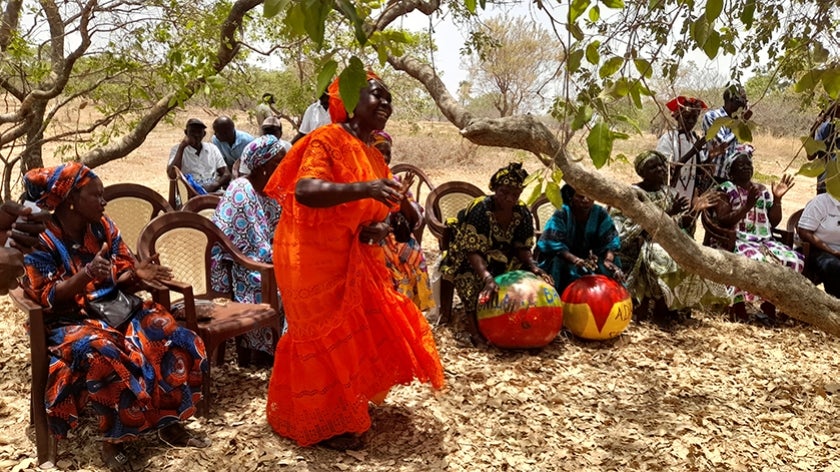 Senegalese women singing and dancing under a tree