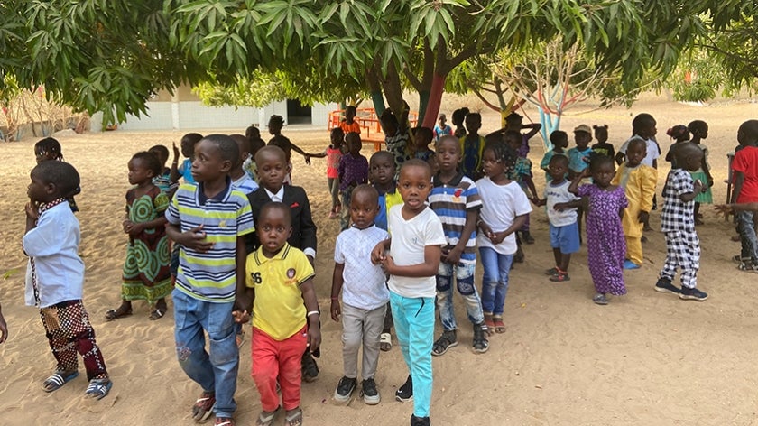 Senegalese children standing under mango tree