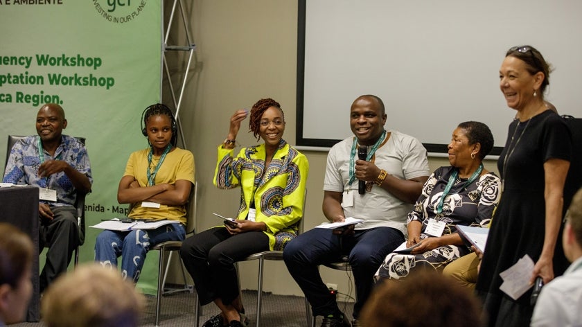 Panelists smile and laugh at an event of the GEF Expanded Constituency Workshop in Mozambique