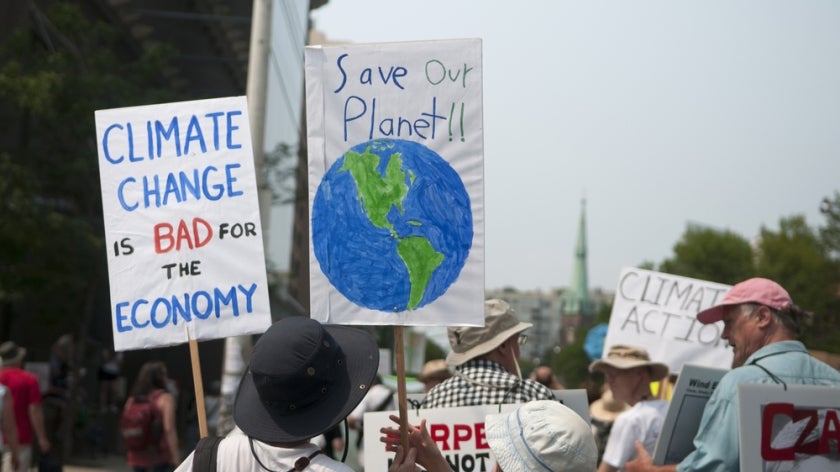 Protesters with signs urging to save the planet with climate control. July, 2015, Toronto, Canada.