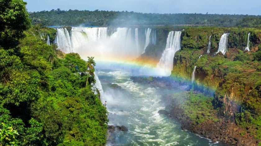 Iguazu Falls on the border of Brazil, Argentina, and Paraguay with rainbow in foreground