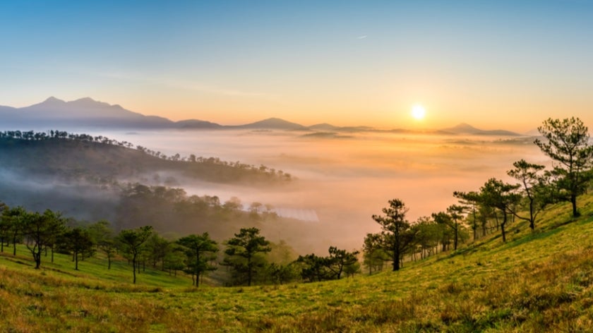 Sunrise near Da Lat City, Vietnam overlooking mountains and forests