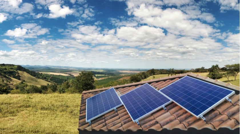 Solar panels on roof with mountain and valley landscape in background