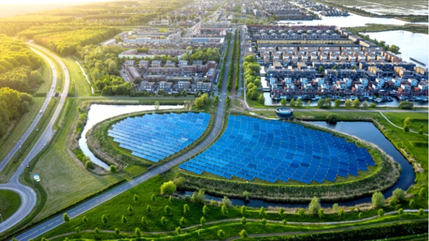Modern sustainable neighborhood in Almere, The Netherlands. The city heating in the district is partially powered by a solar panel island. Aerial view.