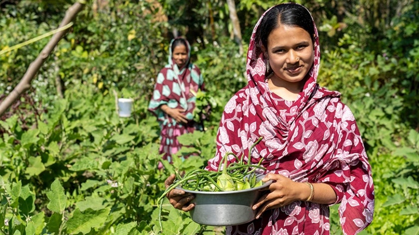 Bangladeshi woman holding crop haul