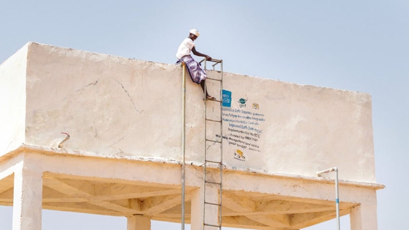 Somali man atop platform and ladder
